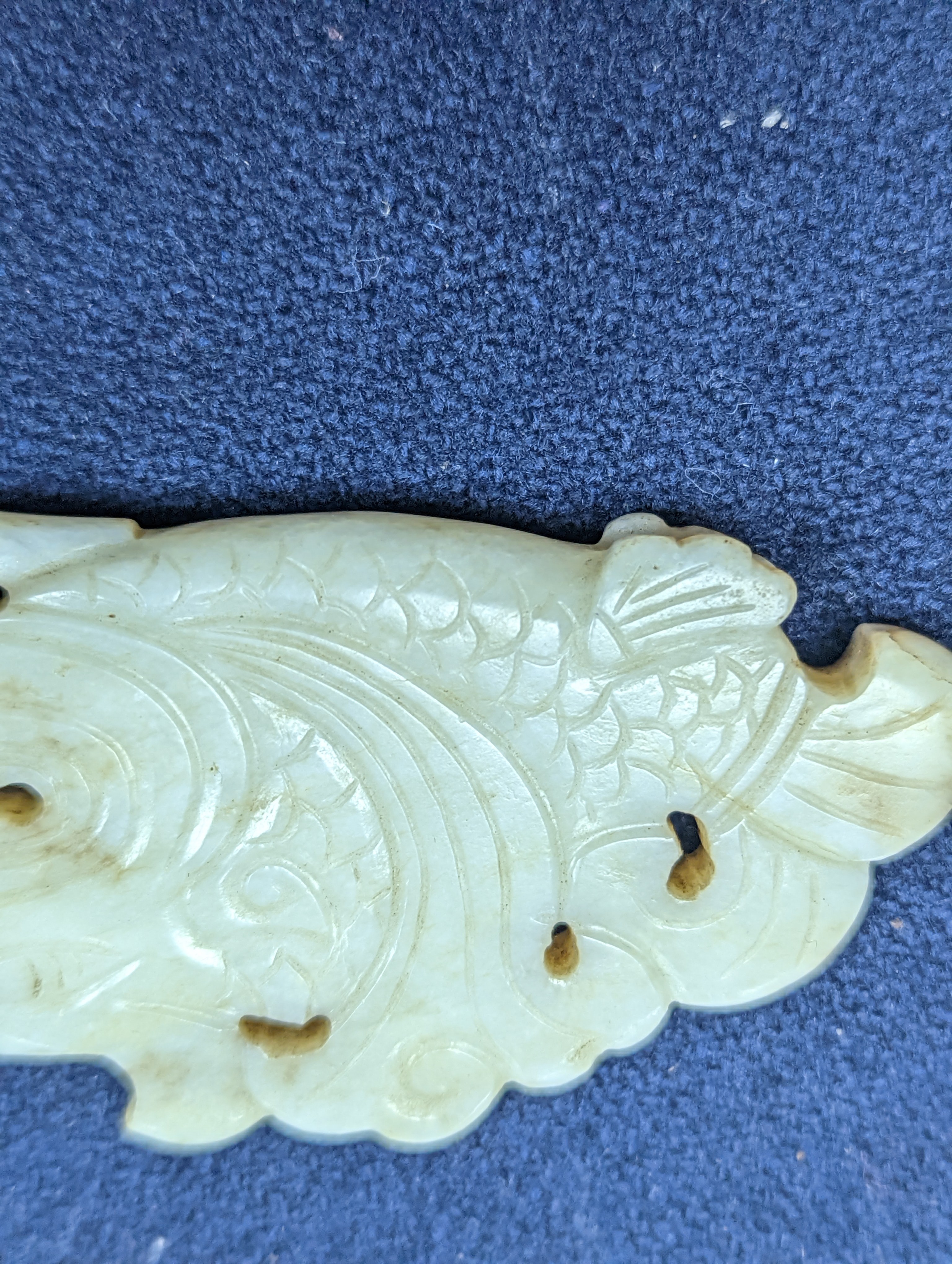 A Chinese white and black jade ‘dragon-fish’ plaque, 19th/20th century, 6cm